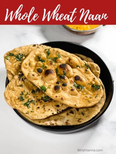A plate of whole wheat naan is on the surface.