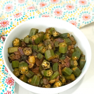A bowl of food on a plate, with Okra