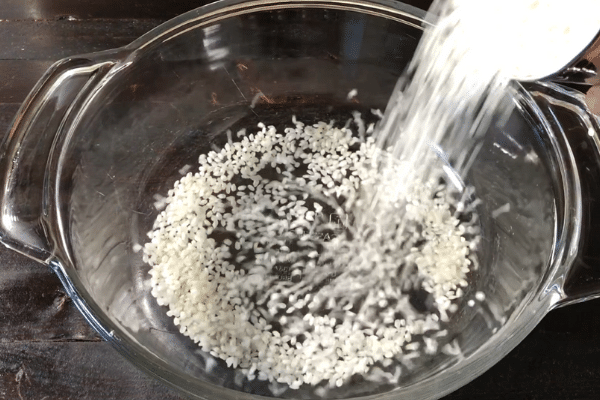 A pan filled with food, with Neer dosa and Rice