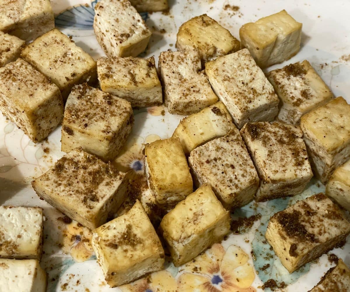 A plate is with air fried tofu cubes.