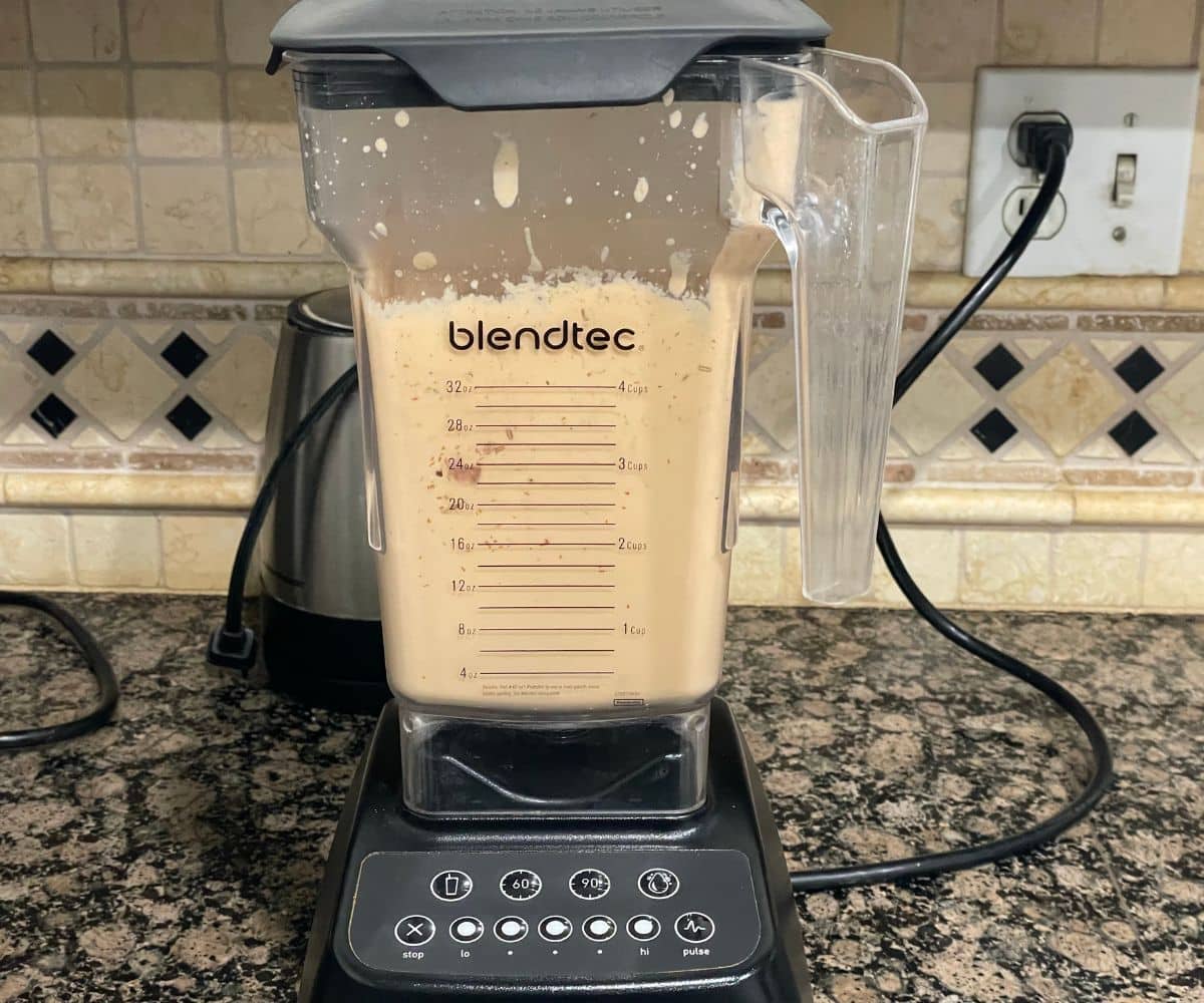 A blender is with tofu butter masala sauce.