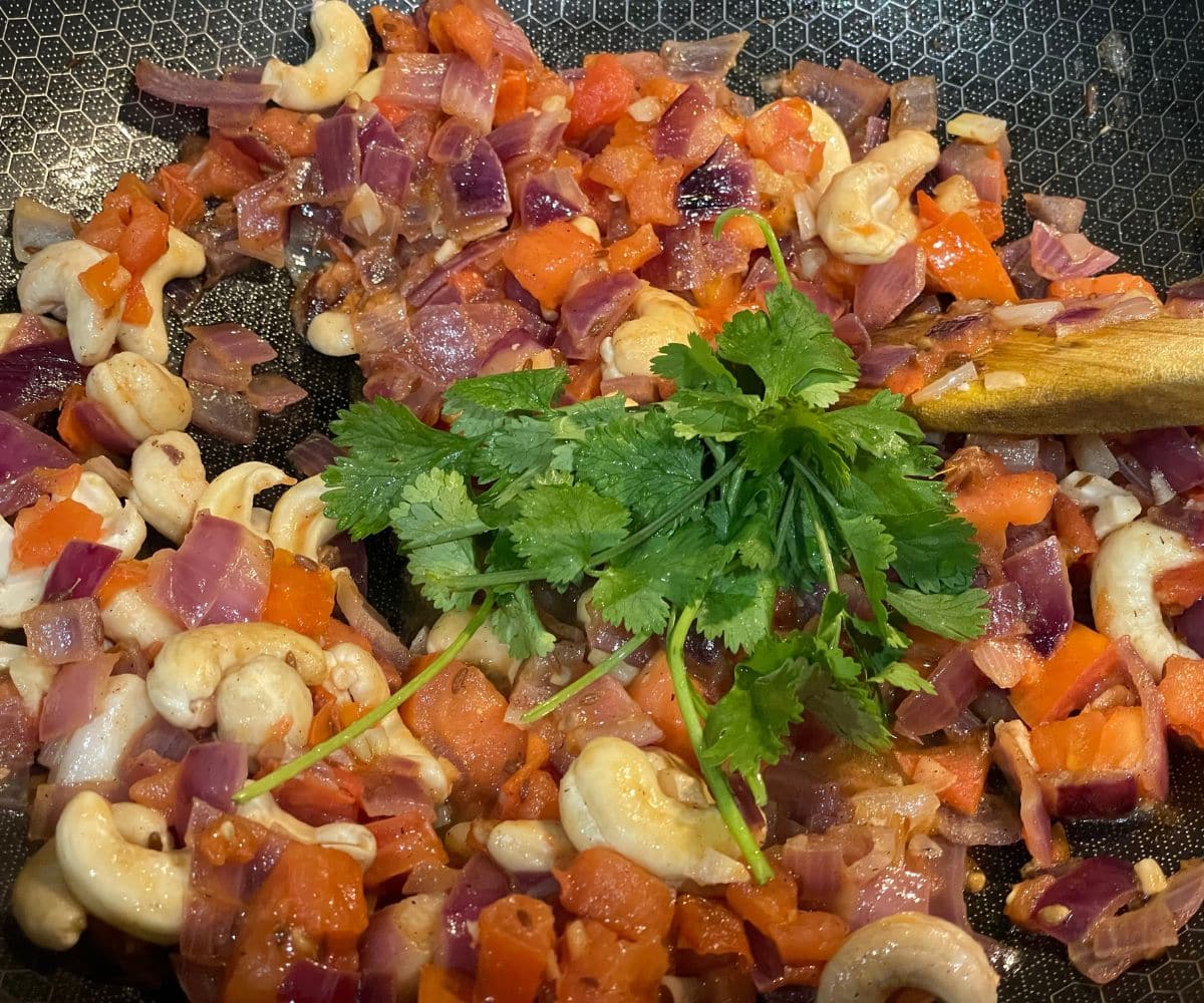 A pan is with tofu butter masala gravy ingredients.
