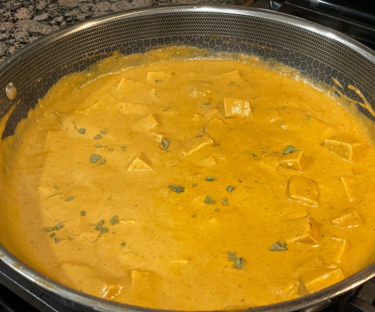 A pan is full of vegan tofu butter masala curry.