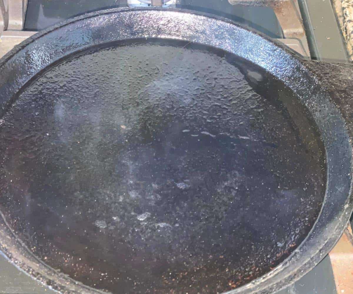 Heated tawa is on the stovetop.