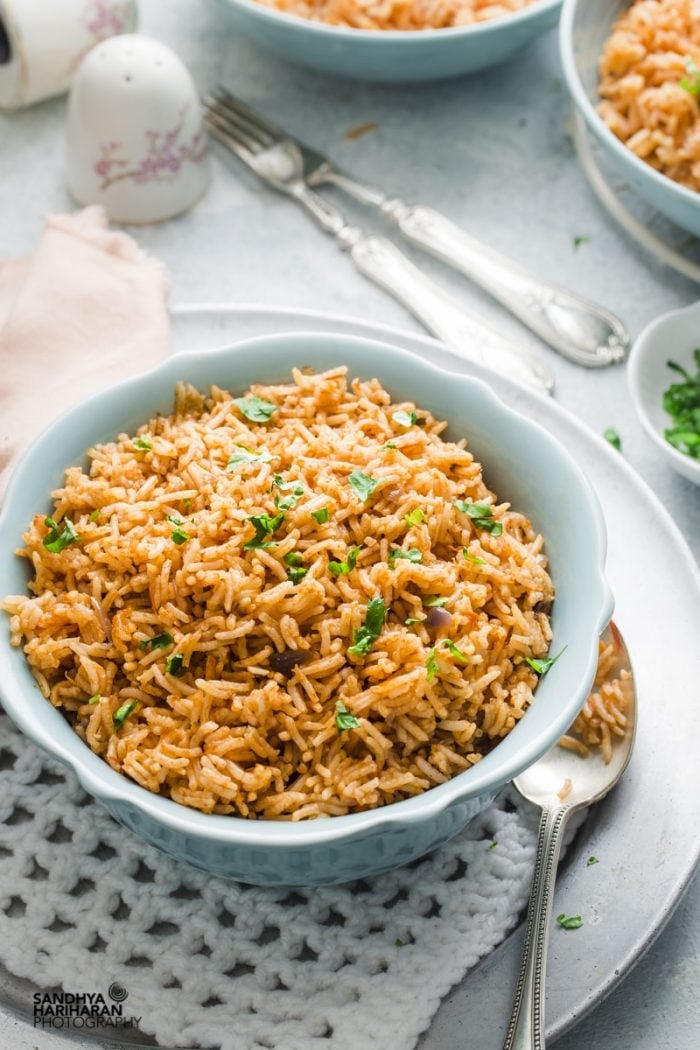 A bowl of food on a plate, with Rice and Pilaf