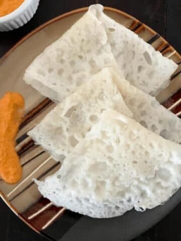 A plate of neer dosa is on the table