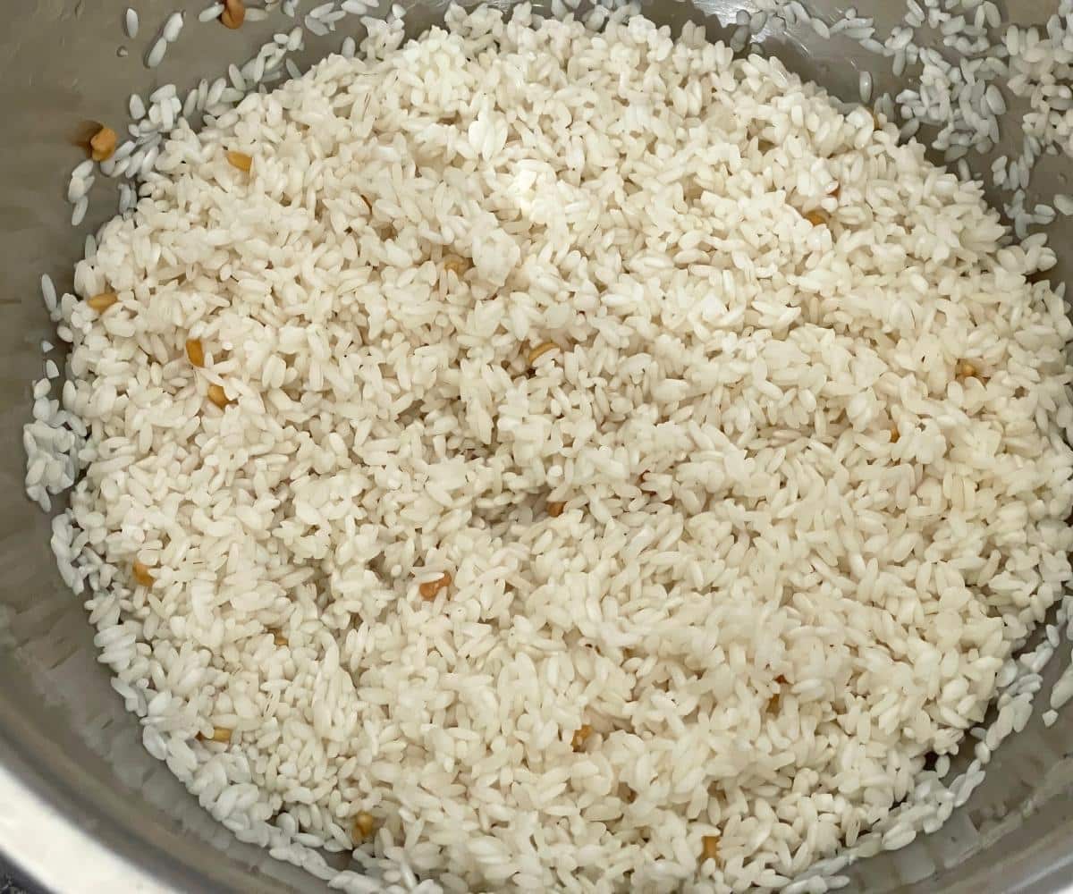 A bowl is with soaked rice and fenugreek for neer dosa recipe.