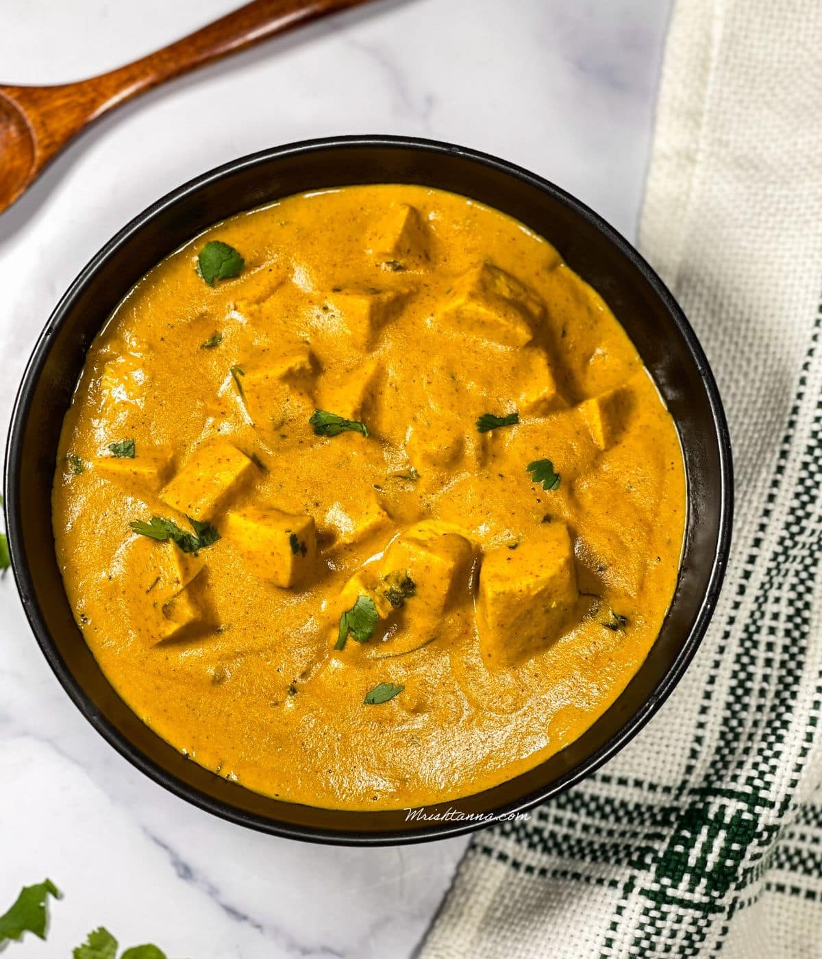 A bowl is filled with tofu butter masala.