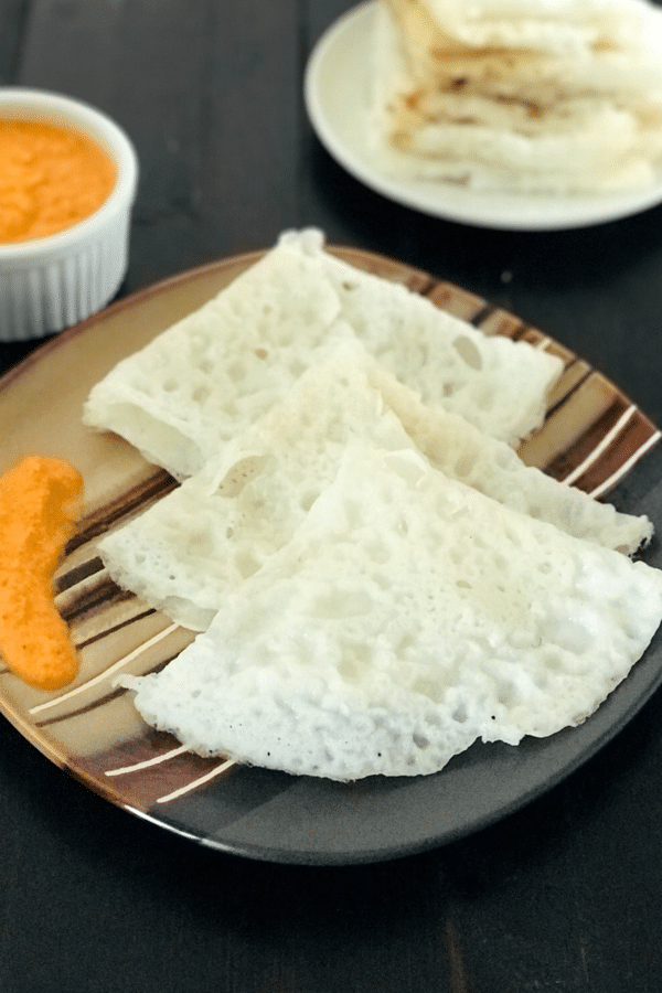 A plate of Neer dosa and chutney is on the table