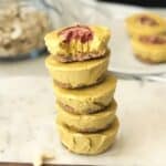 A stack of mini mango no bake cheesecake are on the table.