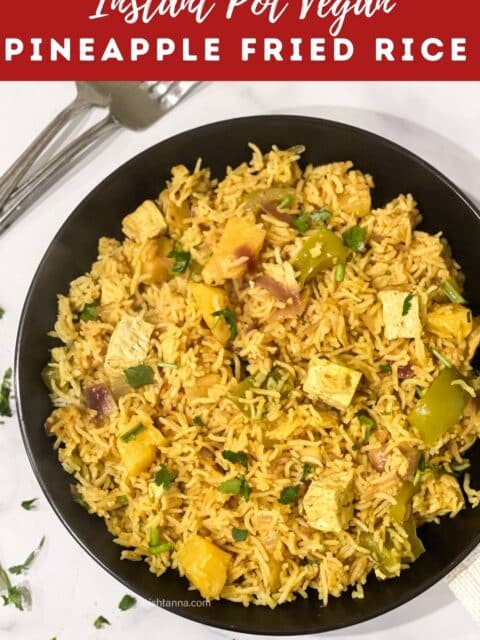 A plate of pineapple fried rice is on the table.