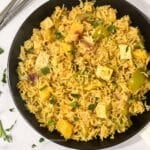 A plate of pineapple fried rice is on the table.