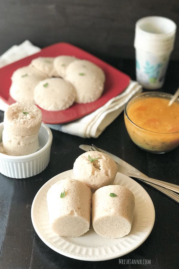 A plate of food, with Idli and Rice
