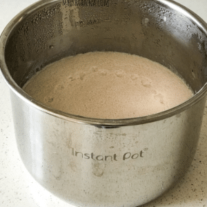 A close up of a batter, with Brown and Idli