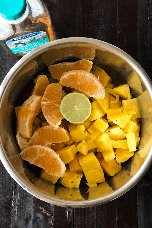 A bowl of fruit, with Jam and Pineapple