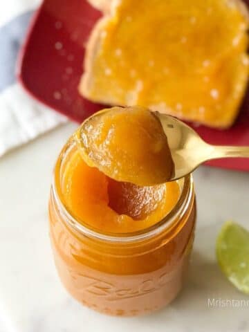 A mason jar is filled with pineapple jam