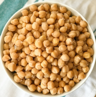 A bowl of food on a plate, with Chickpea