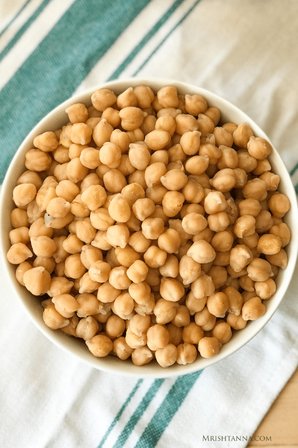 A bowl of food on a plate, with Chickpea