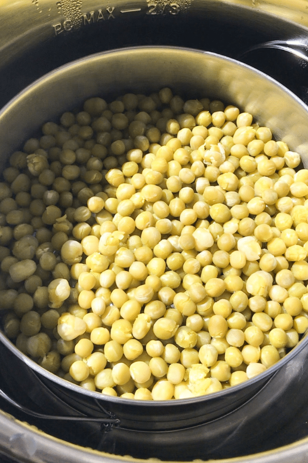 A bowl filled with cooked peas.