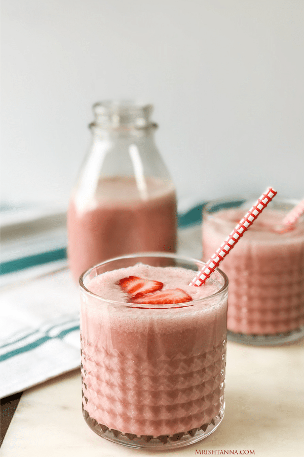 stawberry lassi is poured on a glasses.