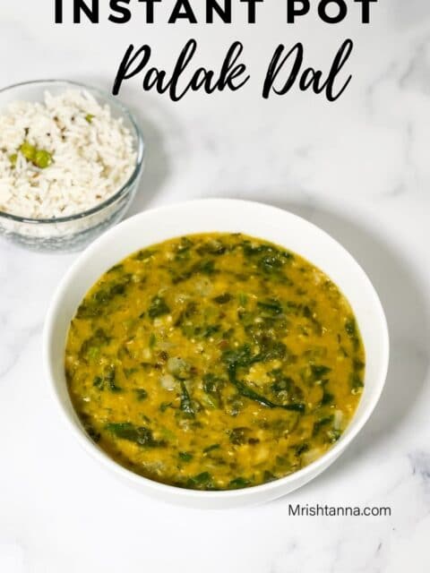 A bowl of palak dal in the white surface.