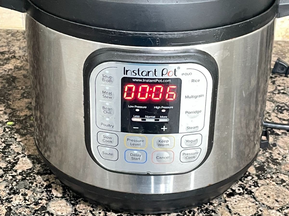 An instant pot displaying cooking time for the dal recipe