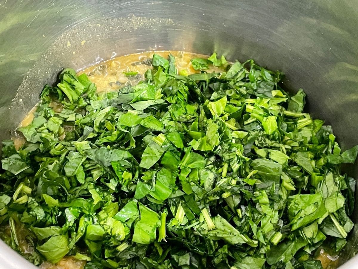 Close up of cooked dal and chopped spinach