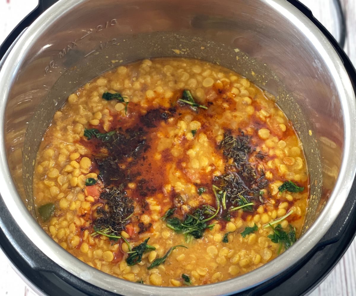 An instat pot is with chana dal and topped with tadka.