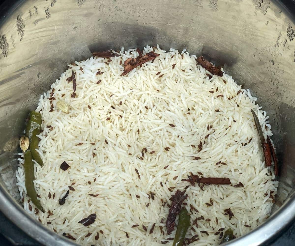 An instant pot has cooked jeera rice.