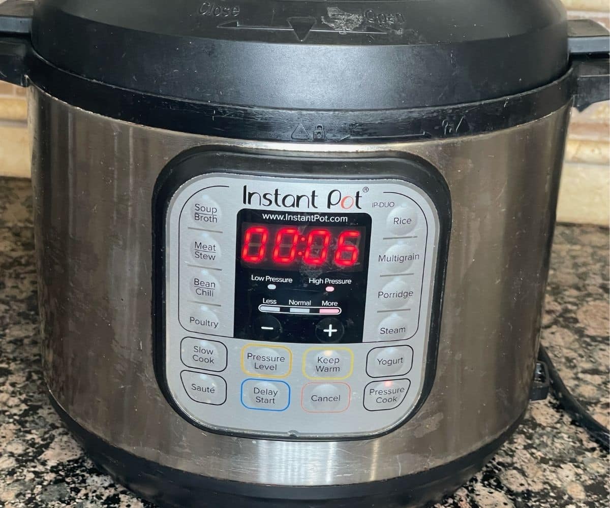 An instant pot showing cooking time for jeera rice.