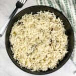 A plate of instant pot jeera rice is on the table.