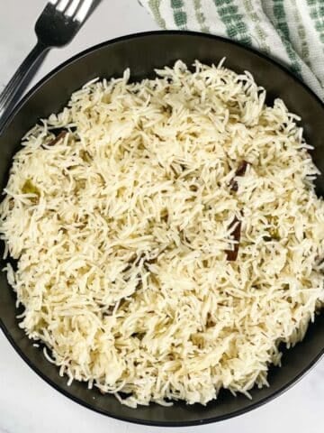 A plate of instant pot jeera rice is on the table.
