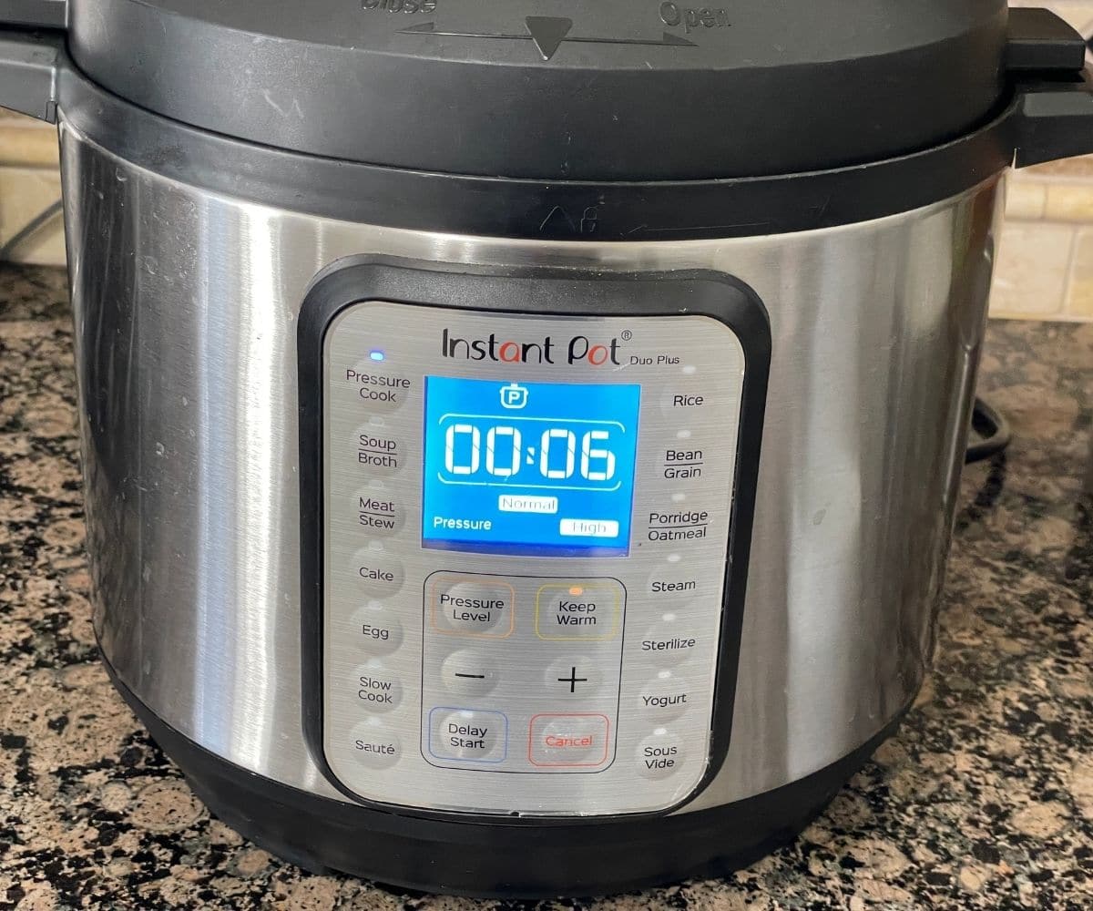 An instant pot displaying cooking time for dal tadka.