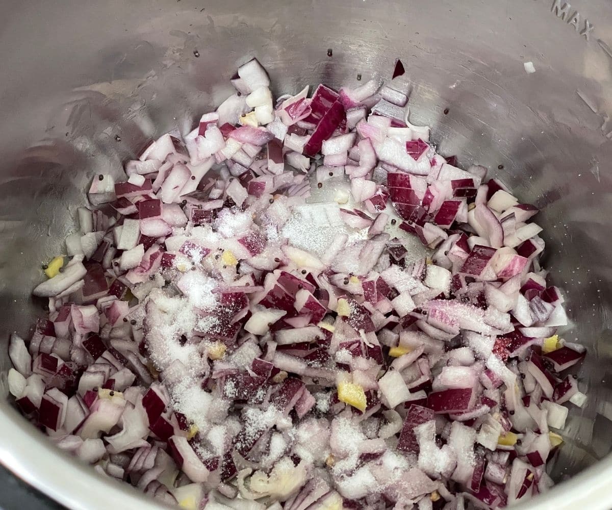 A pot is with chopped onions on saute mode.