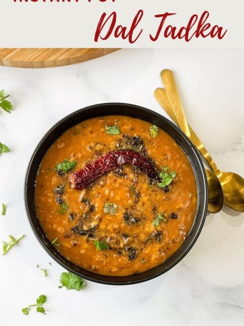 A bowl is with Instant pot dal tadka and topped with cilantro.
