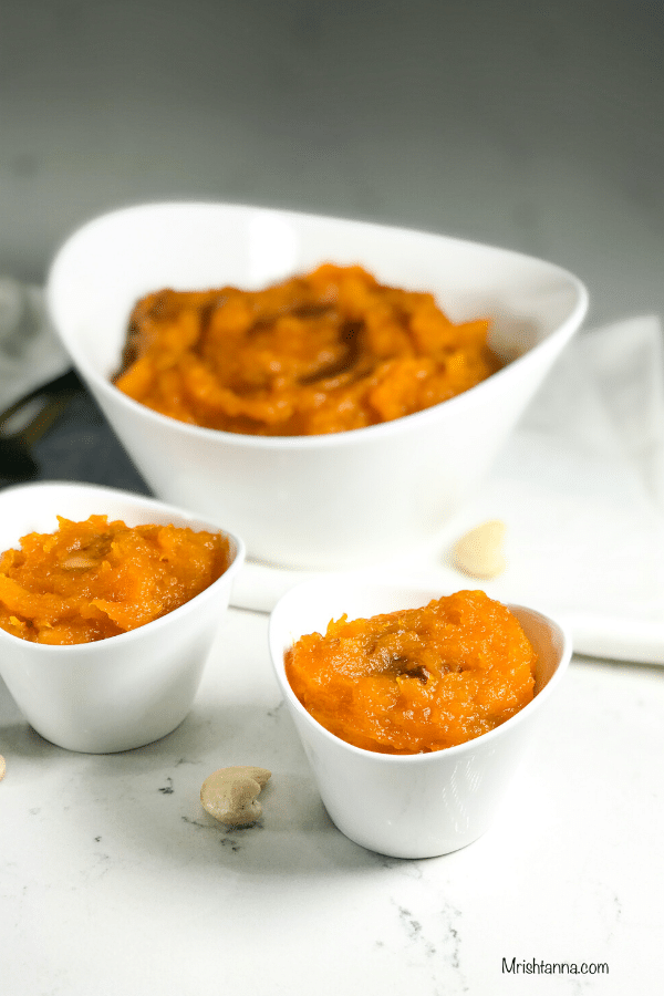 A bowl of food on a table, with Butternut squash and Pudding