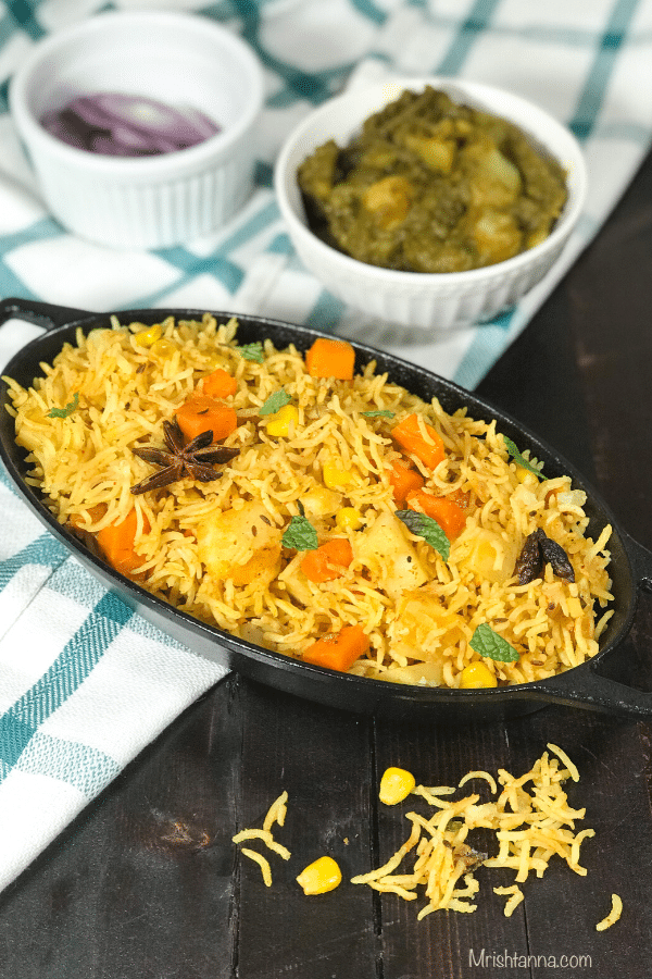 A bowl of food on a plate, with Biryani and Rice