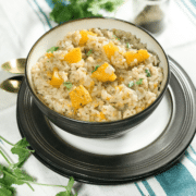 A bowl of squash risotto on the flat surface