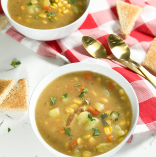 A bowl of soup on a table, with Chowder and Potato