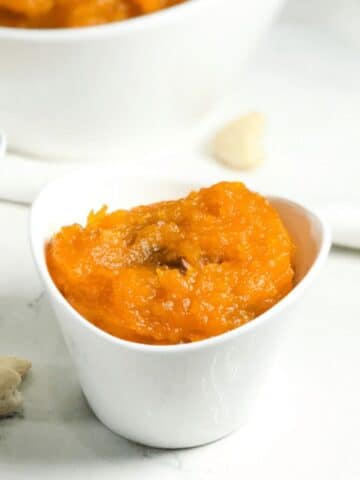 A bowl butternut squash halwa is on the table.
