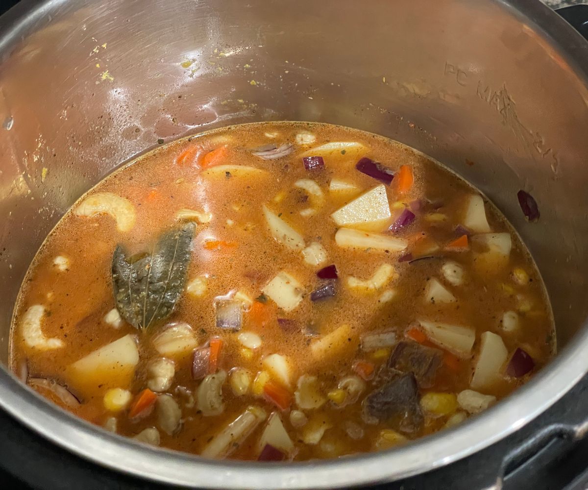 Vegan corn chowder mixture with liquid is in the instant pot.