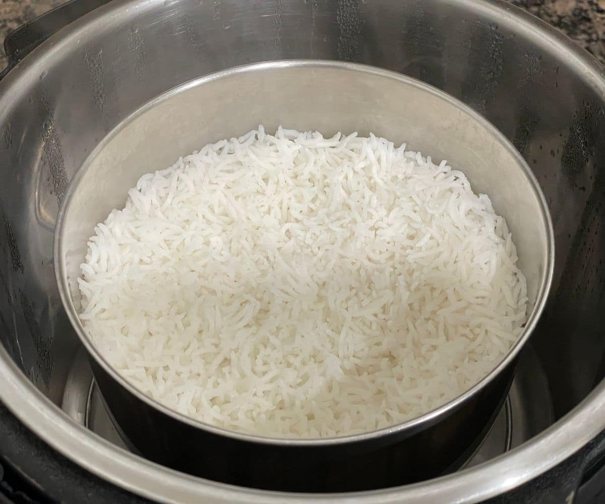 An instant pot is with cooked basmati rice.