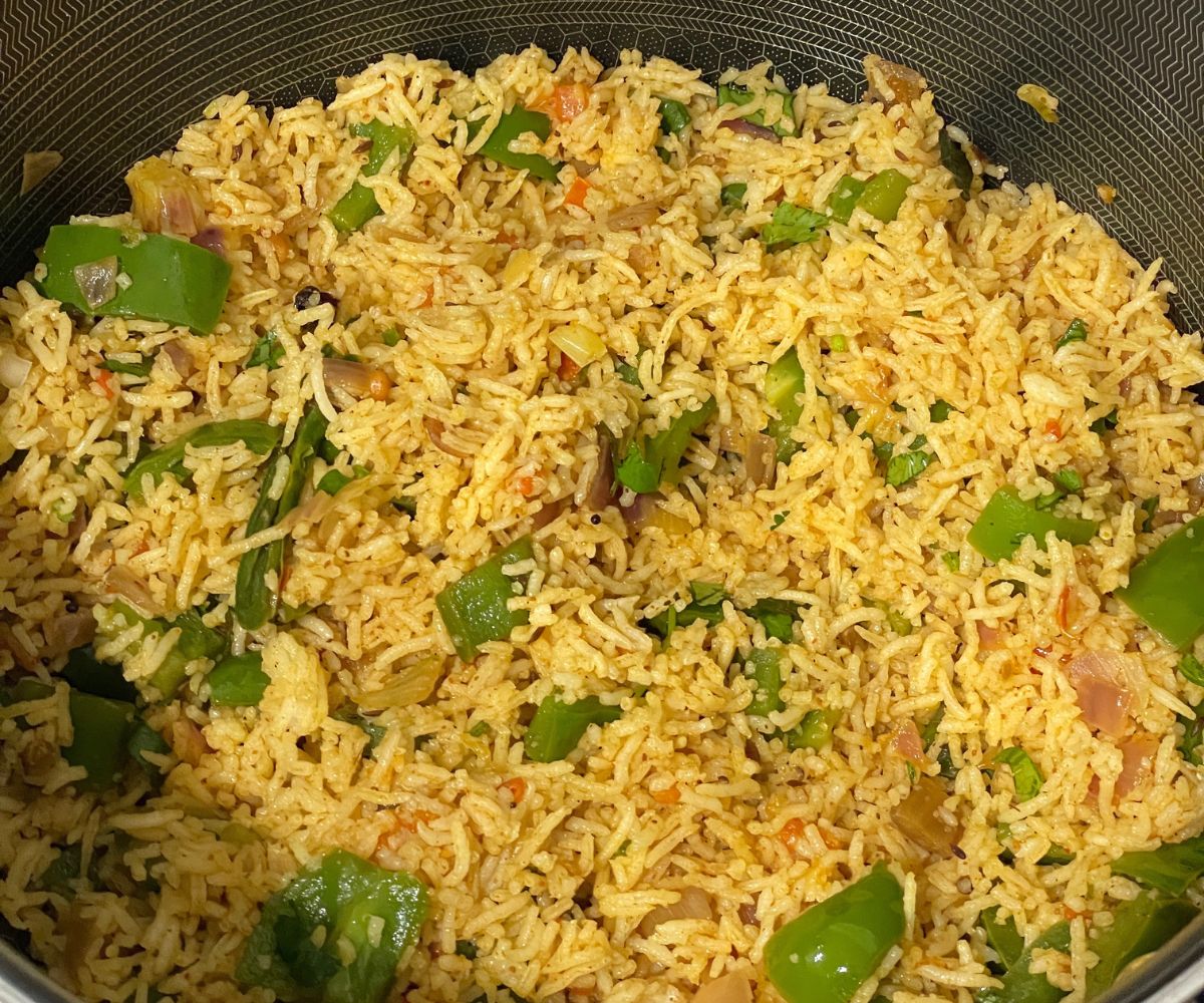 A pot of capsicum masala rice over the counter.