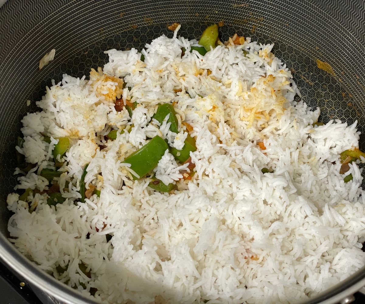 A pan is with capsicum rice.