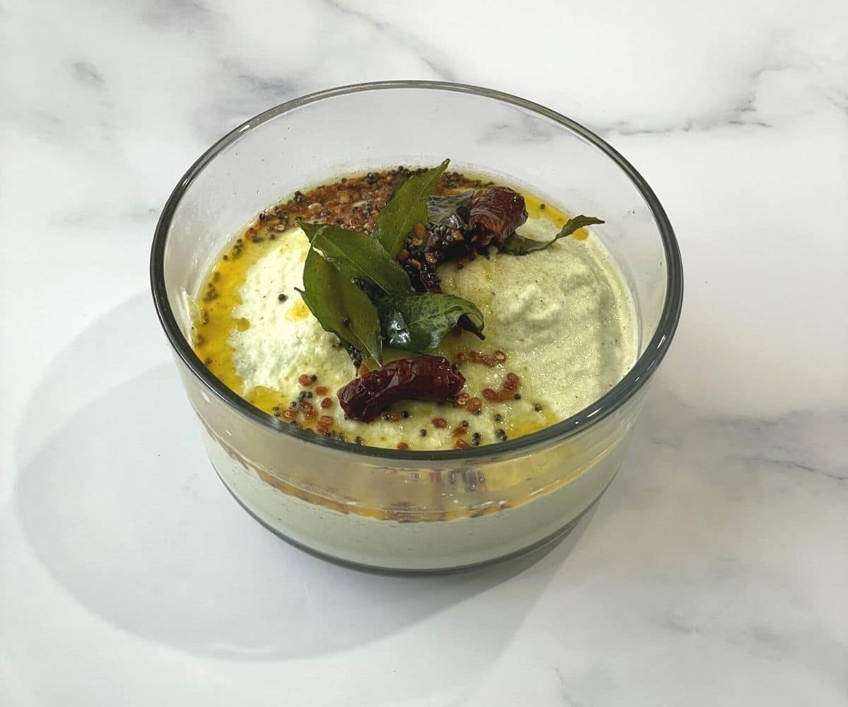 A bowl of coconut chutney and topped with tempering.