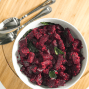 A bowl of food on a plate, with Beetroot