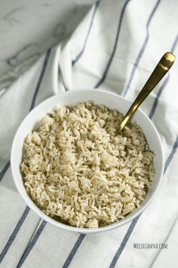 A bowl of rice on a table, with Basmati and Brown rice
