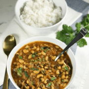 A bowl of curry and rice on a table