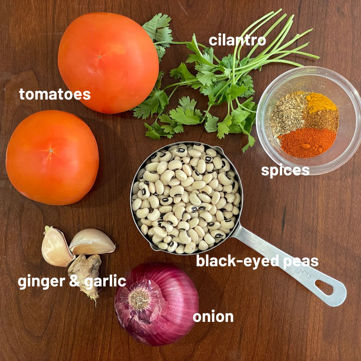 A table is with black-eyed peas curry ingredients.