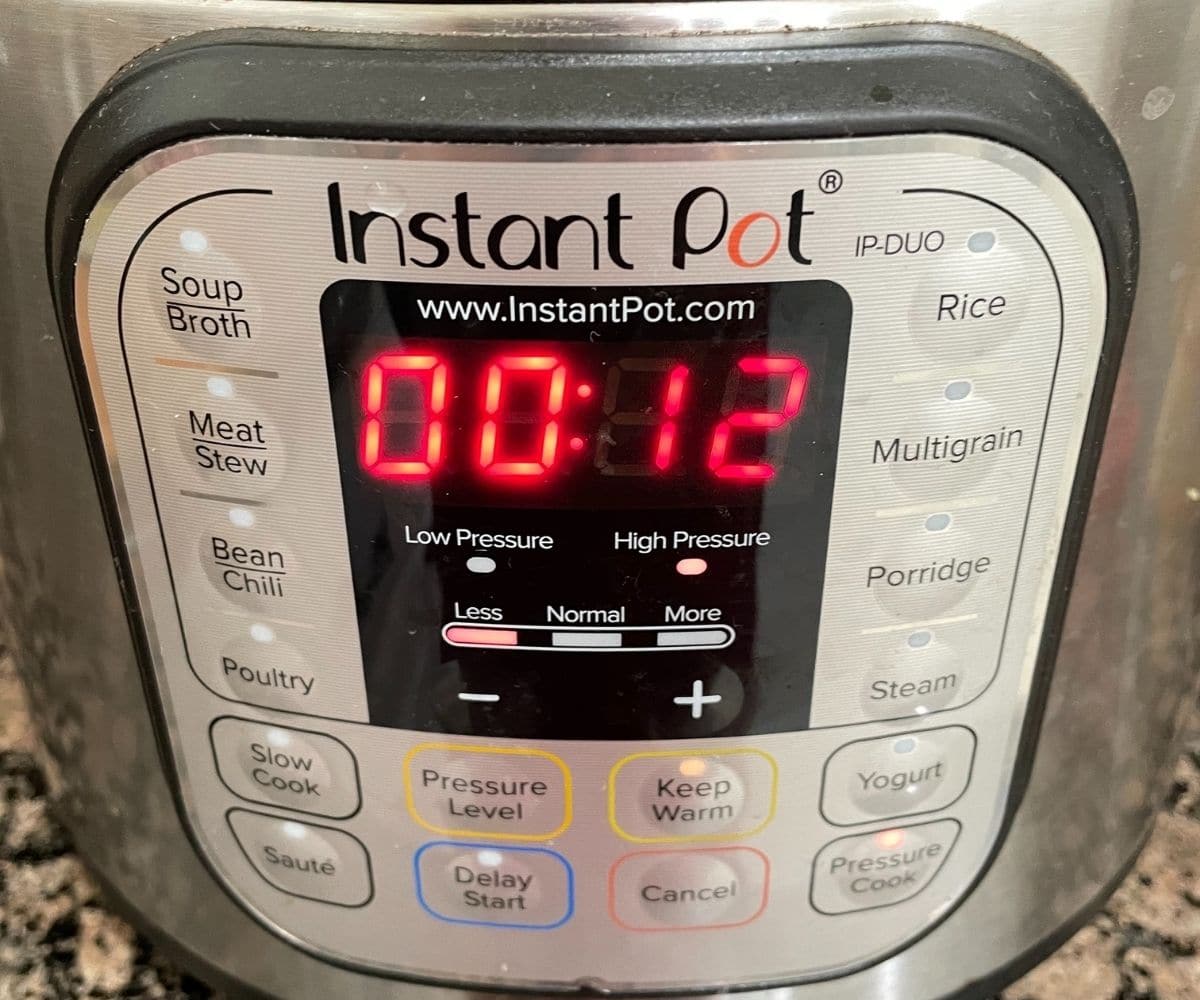 An Instant pot showing cooking mode with number on it